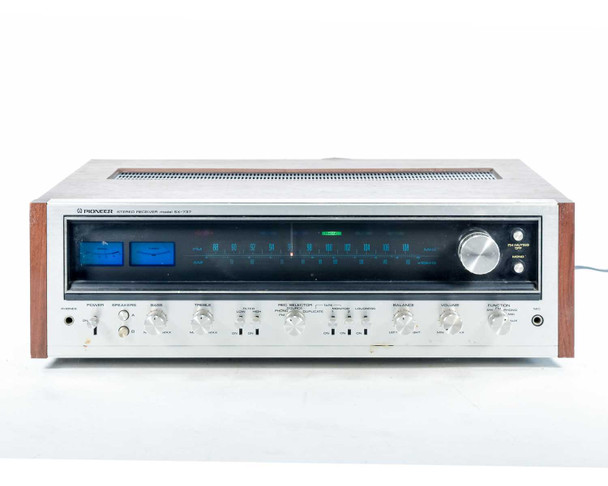 Pioneer SX-737 – powered-on front view with blue tuner dial illuminated, showing tuner scale and signal strength meter