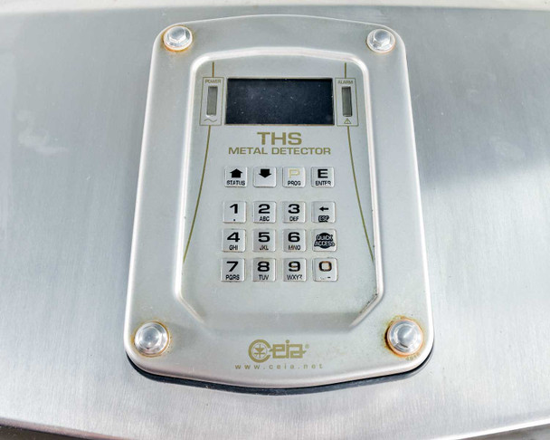 CEIA THS metal detector control interface — close-up of keypad with numeric keys 0-9, function keys, small LCD display, and CEIA branding on brushed aluminum panel