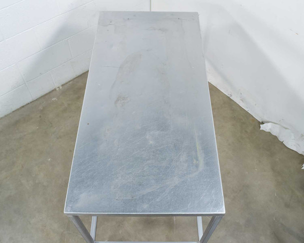 Stainless steel tabletop surface showing light surface marks and general wear – top-down view