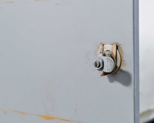 Salsbury 3620 combination lock close-up – rear-load lock mechanism detail showing rust and wear around lock housing