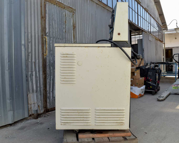 Beckman L5B-CT left side view showing cream/off-white louvered side panel and control console on pallet in warehouse setting