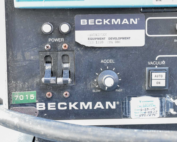 Beckman L5B-CT control panel lower-left detail showing Power switches (two OFF toggles), ACCEL knob (Slow-Fast), Vacuum Auto/On switch, and calibration sticker dated 6-23-15 / 6-23-17 interval 590/275