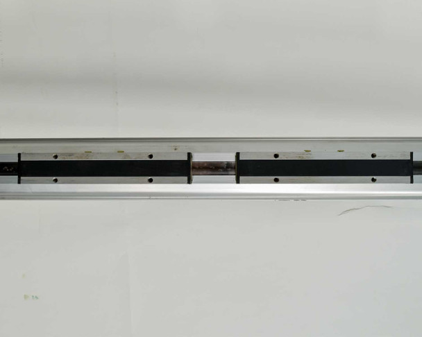 Parker OSP-P50 rodless cylinder top view showing carrier/carriage assembly and mounting rail slots along the body