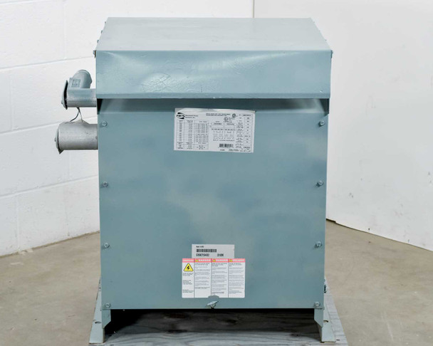 HPS NMF025LE 25KVA transformer – front panel view showing specification label and caution warning sticker; conduit entry visible on upper left