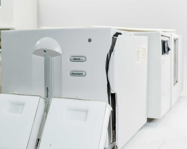 Labsphere RSA-HP-8453 side view showing Blank and Standard sample port buttons and open sample compartment doors, adjacent to HP spectrophotometer