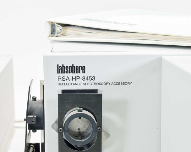 Labsphere RSA-HP-8453 Reflectance Spectroscopy Accessory front panel with sample port and mirror assembly, Labsphere instruction manual binder resting on top