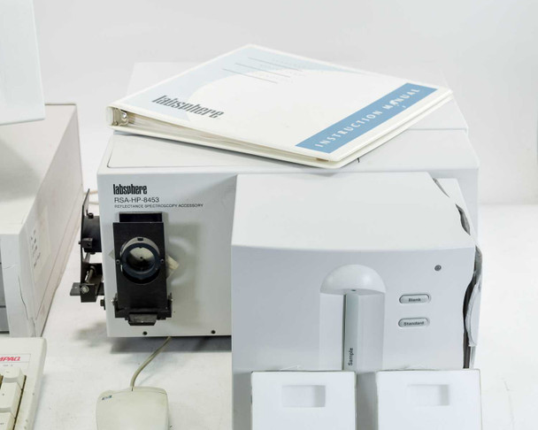 Labsphere RSA-HP-8453 accessory and HP 8453 spectrophotometer side-by-side with Labsphere instruction manual on top