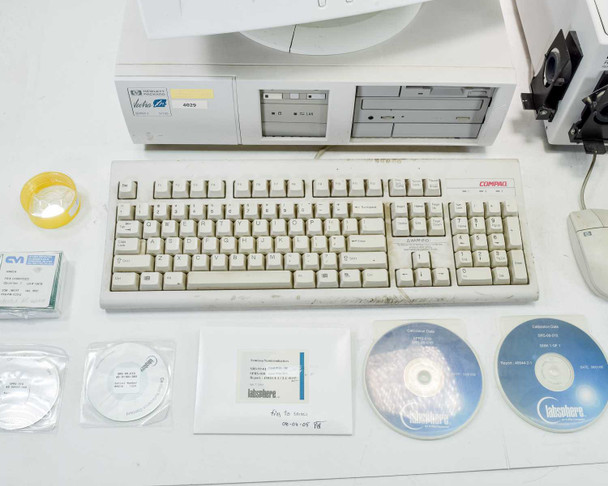 HP Vectra XM 5/120 PC, Compaq keyboard, Labsphere CDs and calibration standards, mouse, and accessories laid out on table