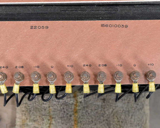 Close-up of copper terminal bus bar showing tap voltage markings 240, 208, -10, 0, +10 with ring terminal wiring