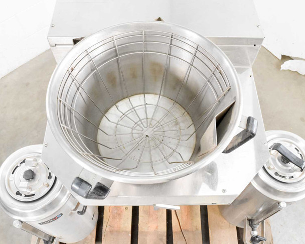 Fetco CBS-61H brew basket interior from above showing stainless steel spray head and basket ring with coffee staining from prior use