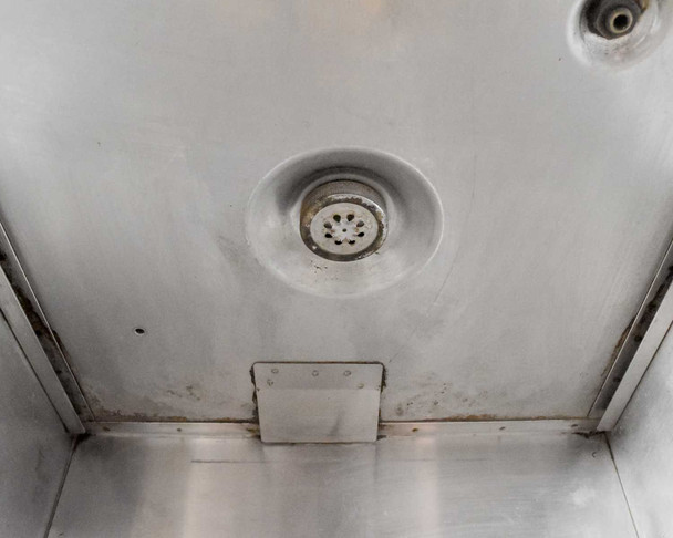 Fetco CBS-61H brew chamber floor interior showing sprayhead diffuser disc and water staining from use