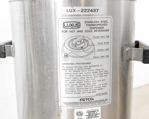 Fetco Luxus thermal dispenser side label showing operating procedures — funnel vent cap, twist cover, safety lock, gauge vent cap instructions