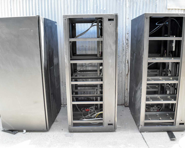 Center Eaton 9395 battery cabinet open from rear – battery tray frames visible with wiring harness and breaker