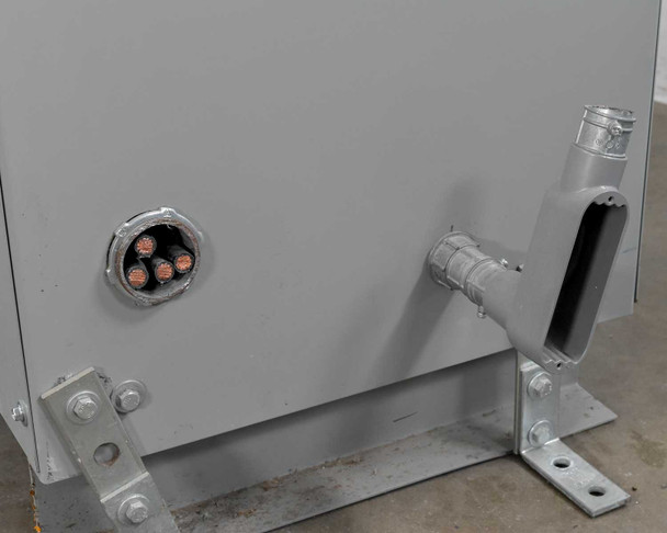 MGM Transformer AD370 – lower left side panel showing primary conduit entry with multi-conductor leads and floor mounting bracket