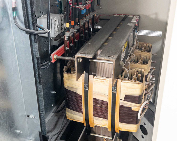 PDI Power Pak M-4 — additional transformer section showing stacked three-phase transformer cores, bus bars, and branch wiring inside lower cabinet