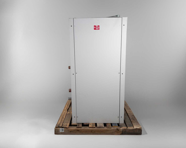 Right side of transfer switch cabinet – blank gray panel with caution label, unit on pallet