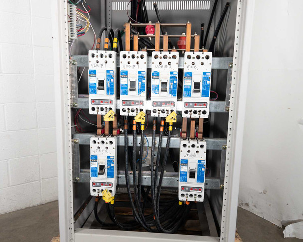 Transfer switch interior panel showing seven Cutler-Hammer HKD breakers mounted in two rows with bus bar wiring