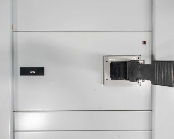 Siemens switchboard main breaker door panel – exterior view of main section door with 'MAIN' label placard and breaker handle protruding