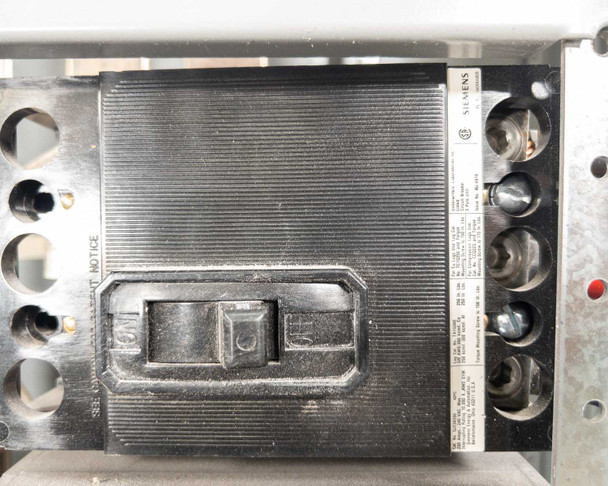 Siemens switchboard branch breaker close-up – single breaker module detail showing toggle handles and side terminal connections with visible dust