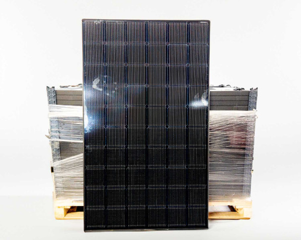 LG LG370M1K-A6 NeON 2 Black 370W AC solar panel standing upright showing full black front face with 60-cell monocrystalline surface, pallet of additional panels visible behind