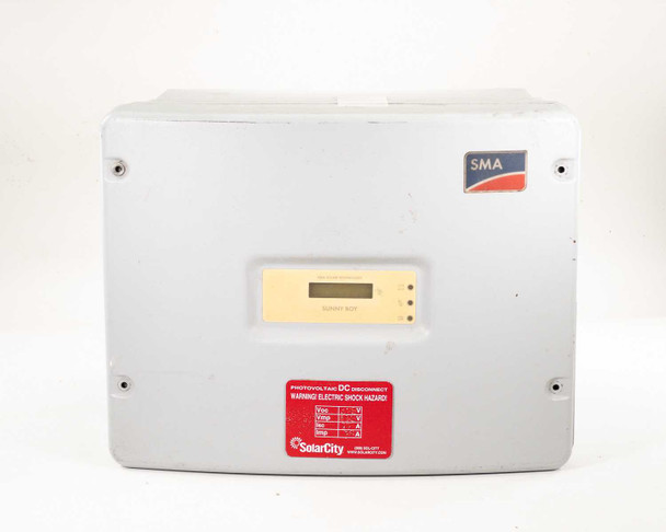 SMA Sunny Boy SB 3800-US-10 solar inverter — slightly angled front view showing enclosure door, LCD display, and SolarCity hazard label