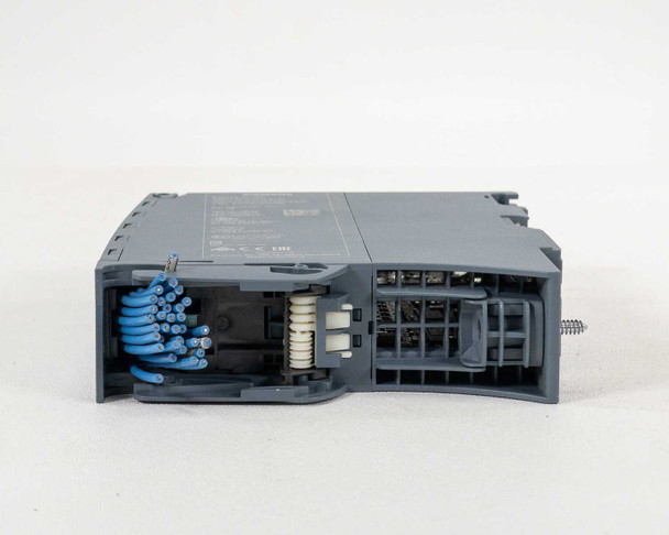 Siemens 6ES7521-1BL00-0AB0 – bottom view with wiring compartment open, showing blue field wiring cables and spring-cage terminals