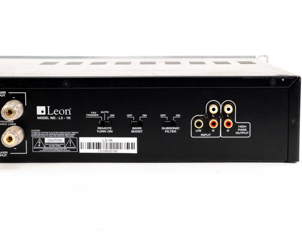 Leon L3-1K rear panel close-up showing 12V trigger, Remote Turn On, Bass Boost, Subsonic Filter switches, LFE and L/R RCA inputs, High Pass Output RCA jacks