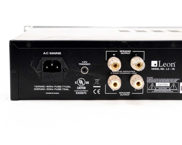 Leon L3-1K rear panel view showing AC Mains IEC inlet, 12V trigger, speaker binding posts, UL and CE markings