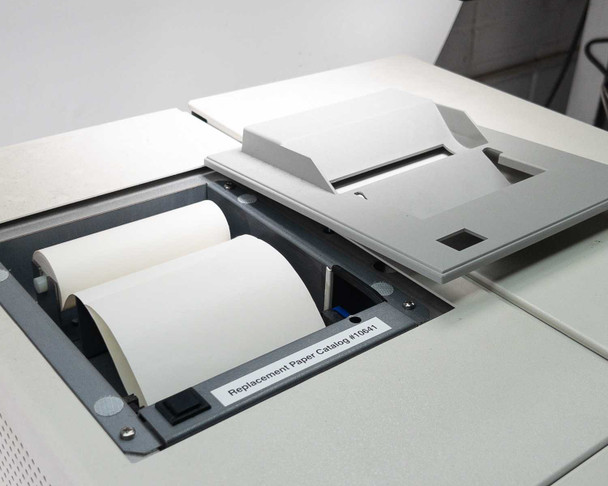 Nova Biomedical BioProfile 100 Plus – top panel open showing two rolls of replacement thermal paper loaded, label reads Replacement Paper Catalog #10641