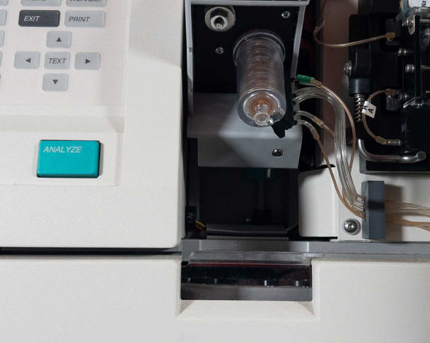 Nova Biomedical BioProfile 100 Plus – close-up of sample compartment with cylindrical sample cup holder, ANALYZE button, and fluidic lines visible