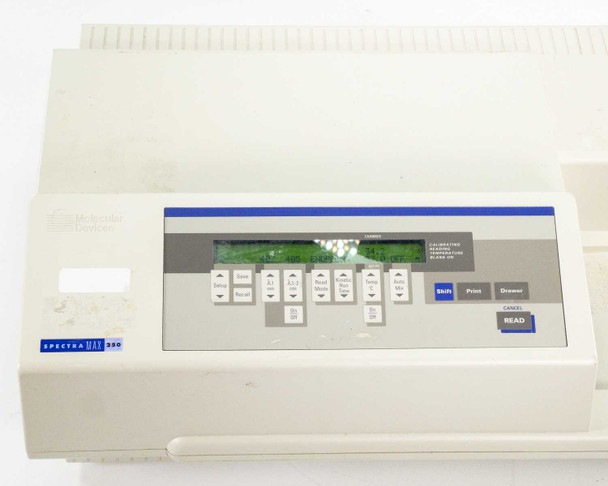 SpectraMax 250 front panel close-up showing illuminated green LCD screen displaying CALIBRATING readout and full keypad layout