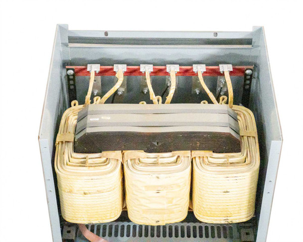 T3045K0034B transformer interior showing three wound coil cores and laminated core stack from above with panel removed