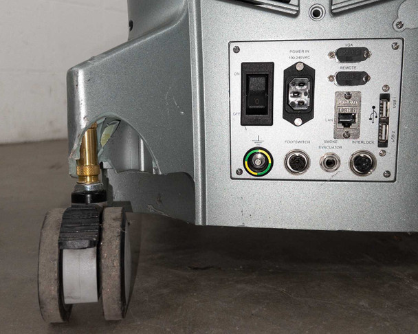 Lumenis AcuPulse 40 rear I/O panel and base — showing power switch, IEC C14 inlet, VGA, Remote DB9, LAN RJ-45, USB ports, footswitch, smoke evacuator, interlock connectors, and locking caster