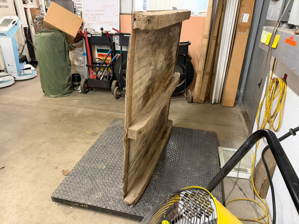 Side profile view of 48x48 treated wood pallet on scale showing runner height and overall thickness