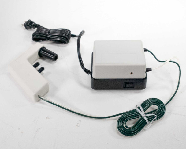 Drummond Pipet-Aid DP-111 pump unit with on/off switch, filter adapter handpiece, and coiled green tubing – top view showing power switch