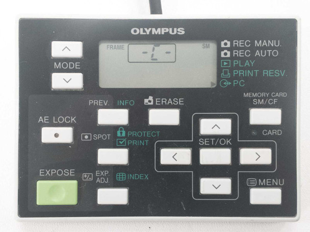 Olympus hand switch controller close-up showing MODE, AE LOCK, EXPOSE, ERASE, SET/OK, MENU buttons and SM/CF card indicator