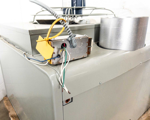 Modine PD400AA0181 – top rear corner close-up showing control/ignition box with yellow dust cap, wiring, and flue collar