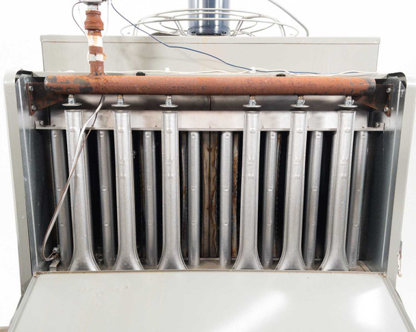 Modine PD400AA0181 – interior view with front panel removed showing multi-tube heat exchanger array and copper gas manifold pipe across top