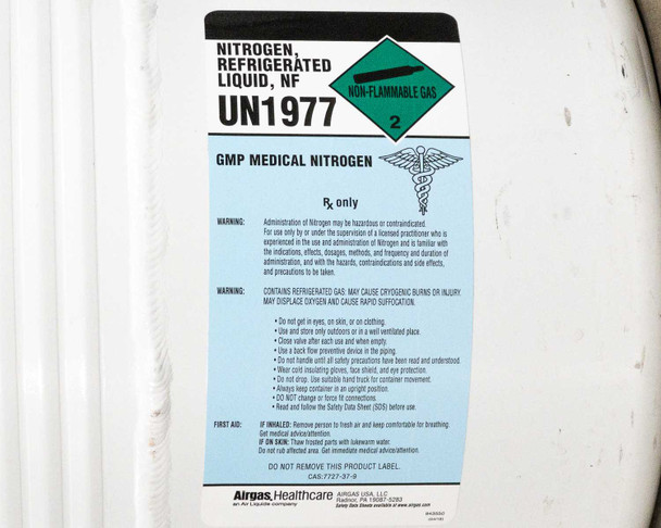 Close-up of Airgas Healthcare GMP Medical Nitrogen UN1977 label with safety warnings on tank body