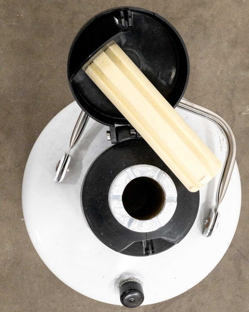 Top-down view with lid open showing one dipping canister resting across neck and inner bore visible