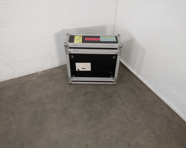 Tour Supply ATA flight case closed, front view showing black laminate exterior, aluminum extrusions, steel ball corners, and tour labels on top