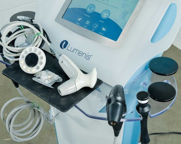 Lumenis NuEra Tight handset tray close-up showing face handset, bipolar handset, RF heads, and grounding pad