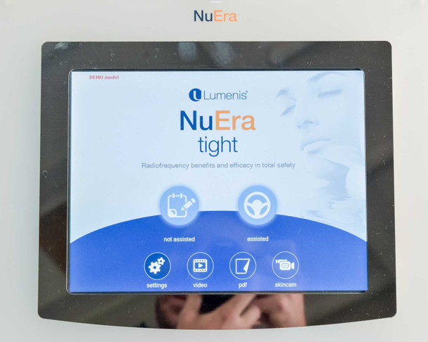 Lumenis NuEra Tight touchscreen home screen showing NuEra Tight logo, not-assisted and assisted mode icons