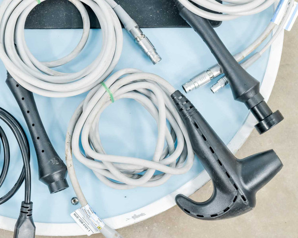 Lumenis NuEra Tight handsets close-up showing two dark gray body/bipolar handsets with gray cables