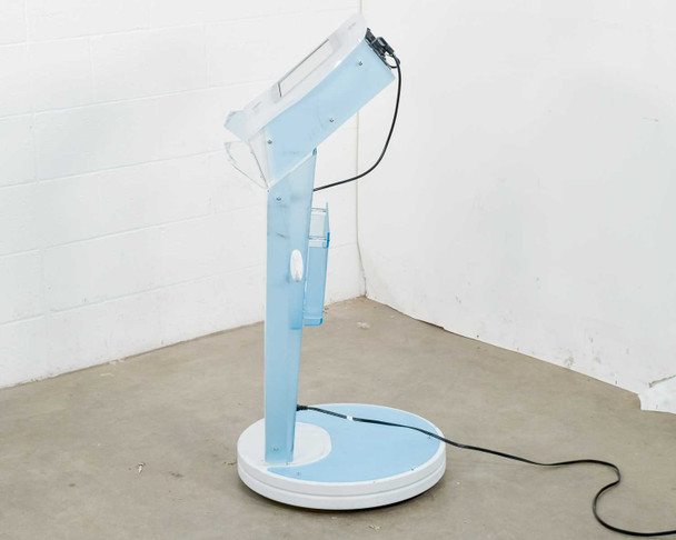 Lumenis NuEra Tight left side profile view showing tilted touchscreen arm and round base with power cord
