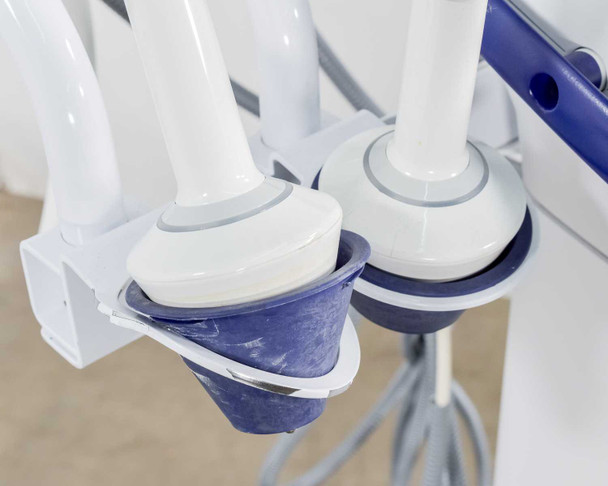 Pollogen Legend+ applicator holders close-up showing two round multi-electrode applicator heads resting in blue-lined cups