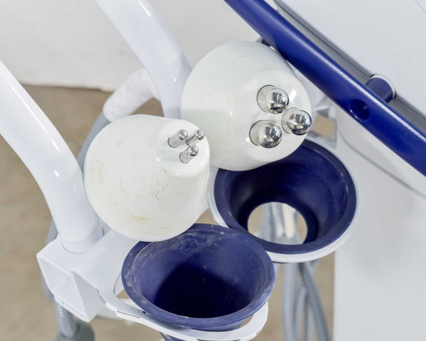 Close-up of Pollogen Legend+ applicator holder cups showing two round multi-electrode heads from above — cosmetic wear visible on cup liners