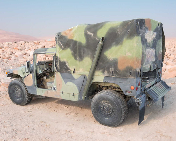 AM General M1152 HMMWV rear three-quarter view showing full soft top cargo enclosure and rear step bumper