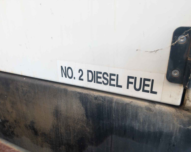 Terex T120 generator enclosure lower panel with No. 2 Diesel Fuel label and diesel staining visible on skid base