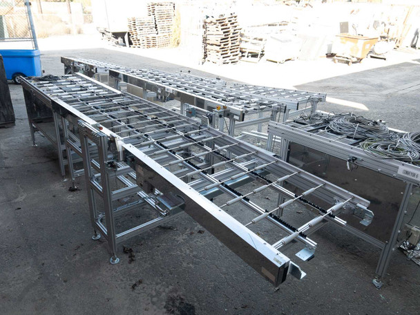 Multiple Excel Flow SC23460 aluminum roller conveyor sections laid out outdoors – top view of roller bed frames
